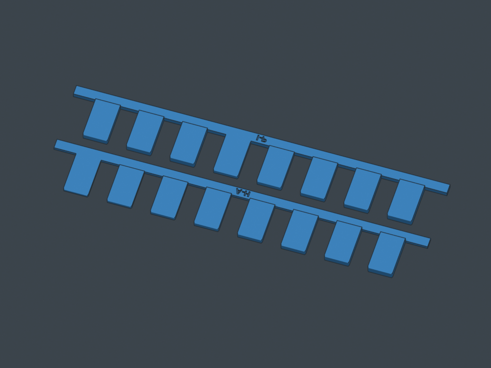 Two labeled combs lying flat with all fingers supported on the bed